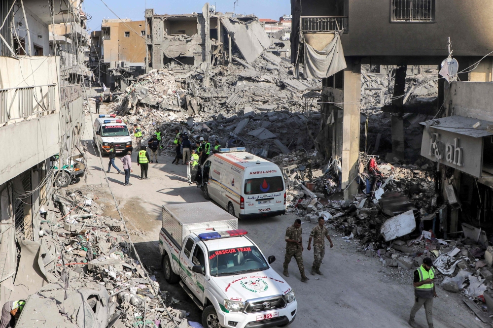 Civil defence rescue vehicles arrive at the site of an overnight Israeli air strike on the village of Qana in southern Lebanon. — AFP 