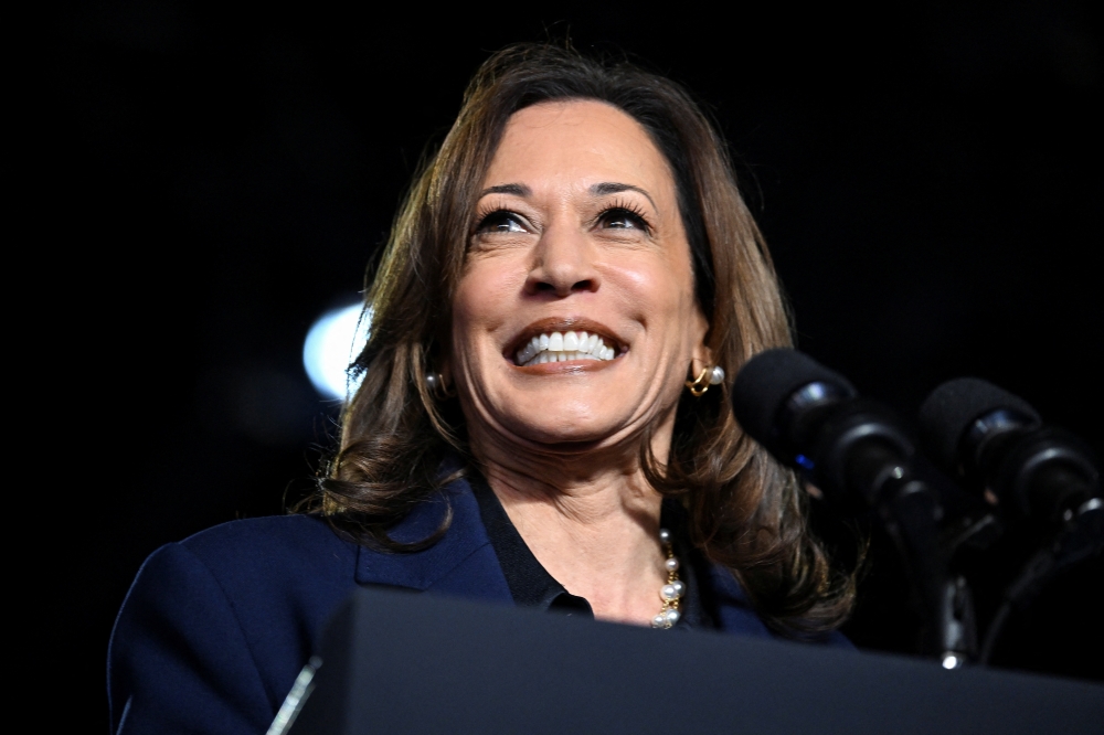 Democratic presidential nominee US Vice President Kamala Harris reacts on stage during a campaign event in Green Bay