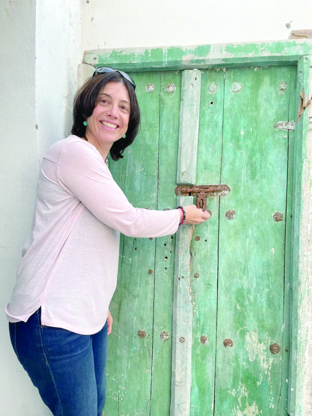 Erin Coyle poses in front of her favourite Omani door in Sur