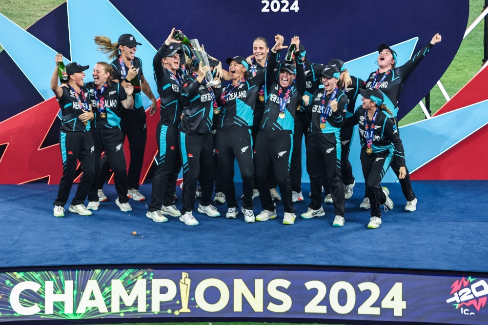 New Zealand's players celebrate with their winning trophy at the end of the ICC Women's T20 World Cup