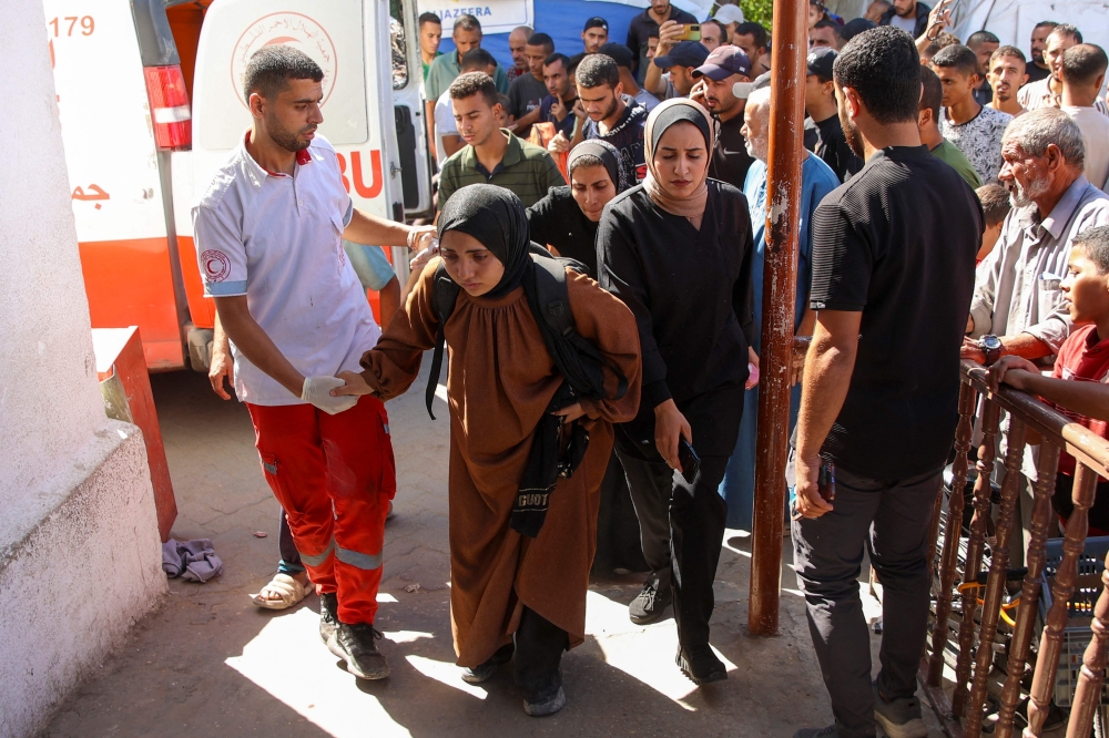 Palestinians who were injured during an Israeli operation arrive at Al-Ahli Arab hospital. — AFP 