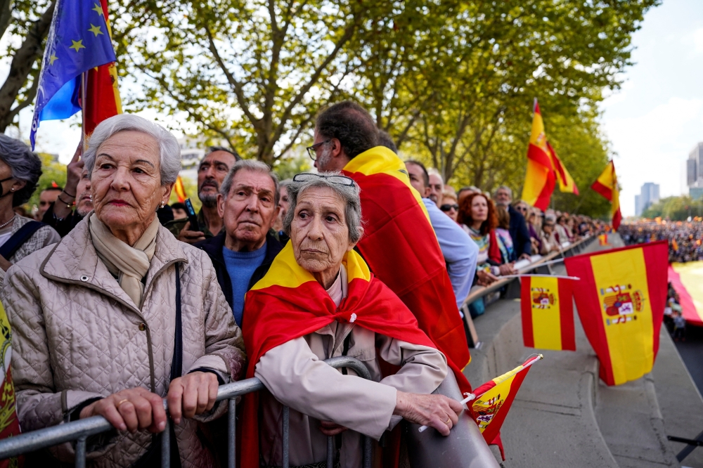 People attend a protest called by conservative and far-right parties, in Madrid. — Reuters file photo 
