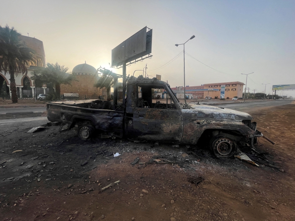 A burned vehicle is seen in Khartoum, Sudan. — Reuters file photo
