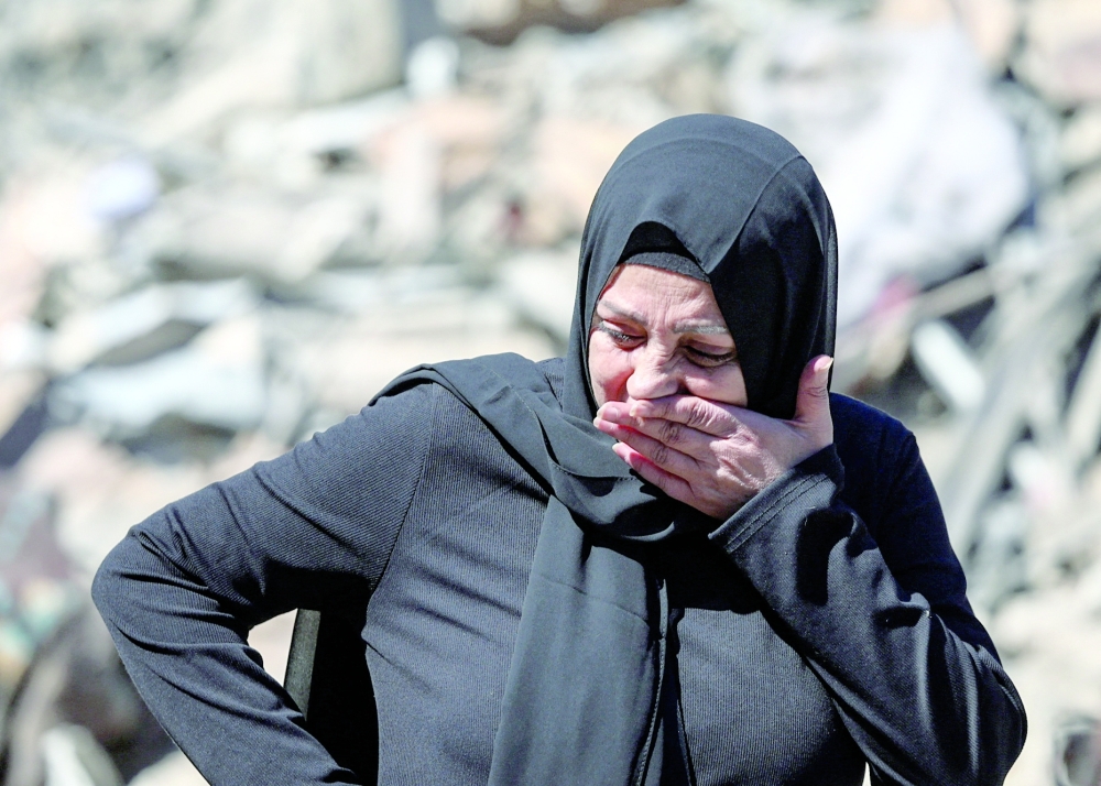 A distressed woman reacts at the site of an Israeli strike near the Rafik Hariri University Hospital in Beirut on Tuesday. — Reuters