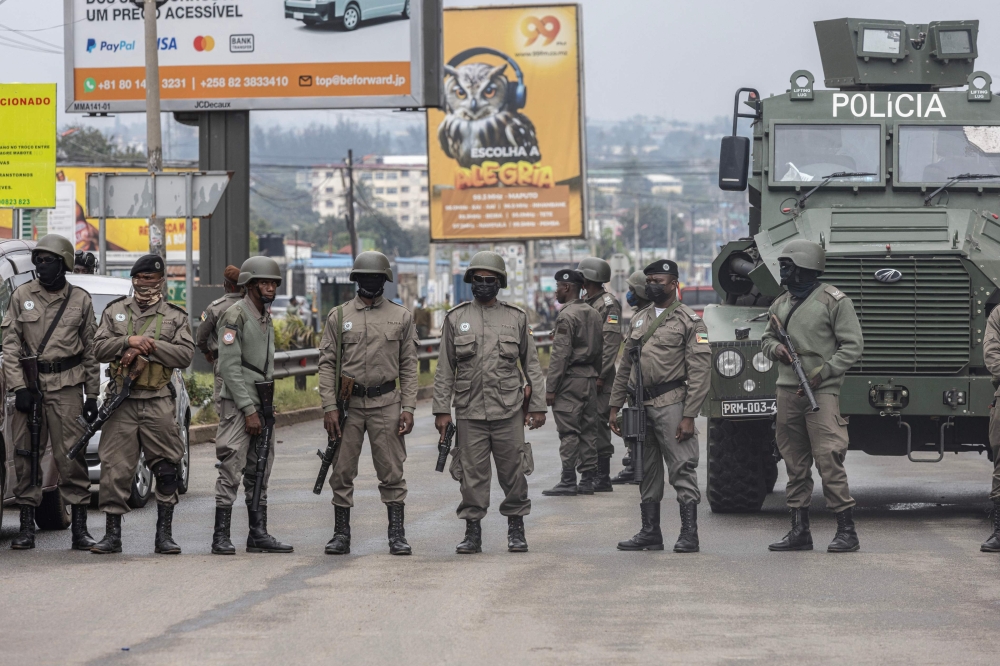 Units of the Mozambican anti-riot police deploy during a march called by the presidential candidate of the Optimist Party for the Development of Mozambique (PODEMOS) in Maputo, on October 21, 2024. A demonstration was dispersed with tear gas on Monday in the capital of Mozambique, which took on the air of a ghost town after a call for a general strike launched by the opponent Venancio Mondlane to denounce fraud during the presidential election, noted AFP. This demonstration comes two days after the assassination of two of the opponent's close associates, including his lawyer who was preparing an appeal to denounce fraud in the election of October 9, the final results of which have not yet been published. (Photo by ALFREDO ZUNIGA / AFP)