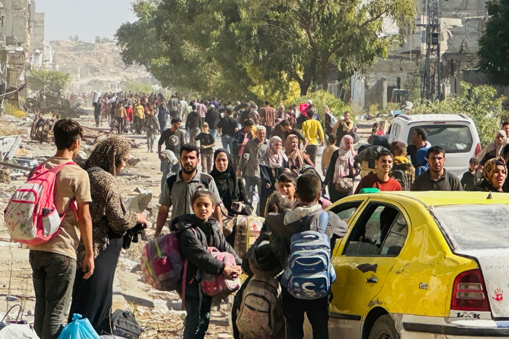 Displaced families fleeing Israeli army operations in Jabalia take the main Salah al-Din road towards Gaza City. — AFP 