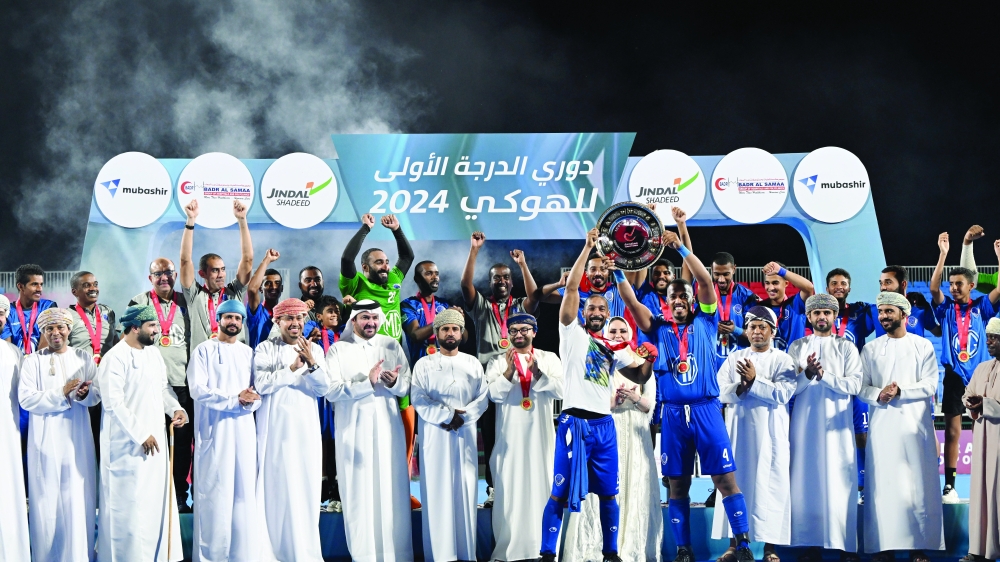 Al Amerat players celebrate with the league shield. -- Abdulwahid al Hamadani