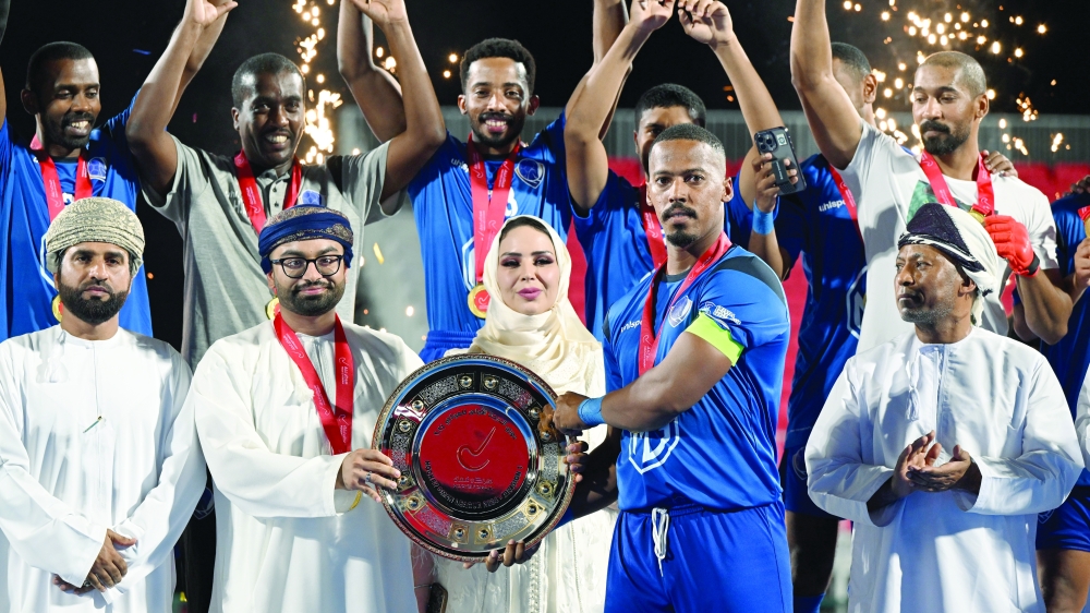 Al Amerat players celebrate with the league shield. -- Abdulwahid al Hamadani