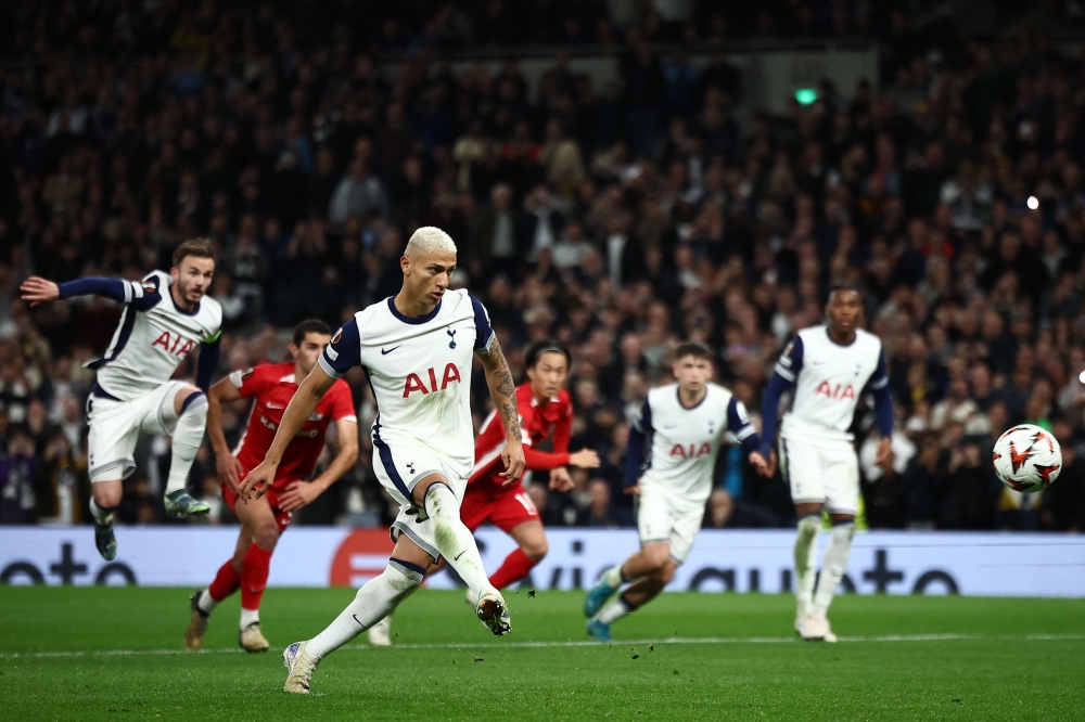 Tottenham Hotspur's Brazilian striker #09 Richarlison scores the opening goal from the penalty spot during the UEFA Europa League