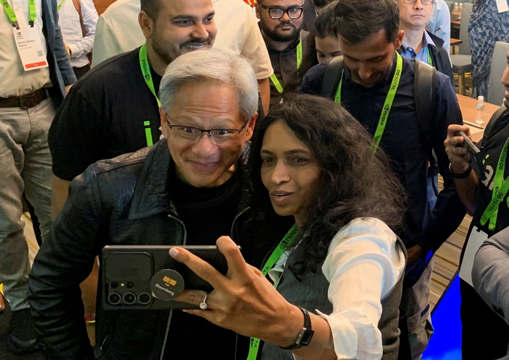 Nvidia CEO Jensen Huang poses for a selfie after a press conference in Mumbai  