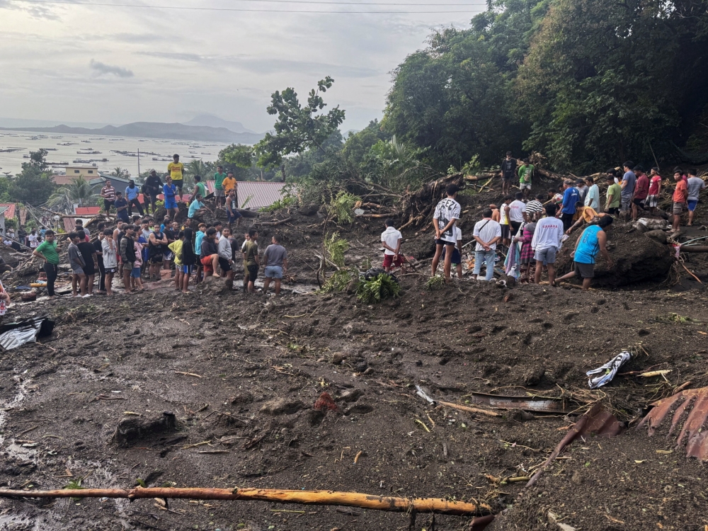 Rescue personnel and residents search for landslide casualties in Batangas province, Philippines. — Reuters file photo 
