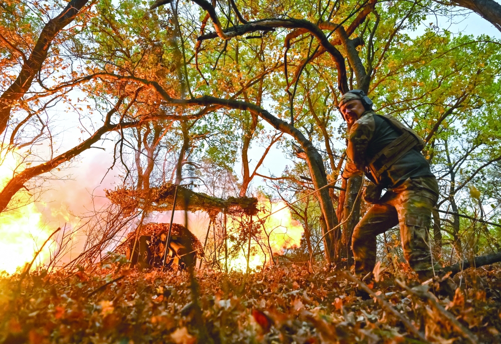 A Ukrainian service member fires towards Russian troops near the frontline city of Toretsk, Ukraine. — Reuters