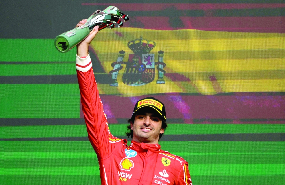 Ferrari's Spanish driver Carlos Sainz rises the winner's trophy after winning the Mexico City Formula One Grand Prix at the Hermanos Rodriguez racetrack, in Mexico City on October 27, 2024.  