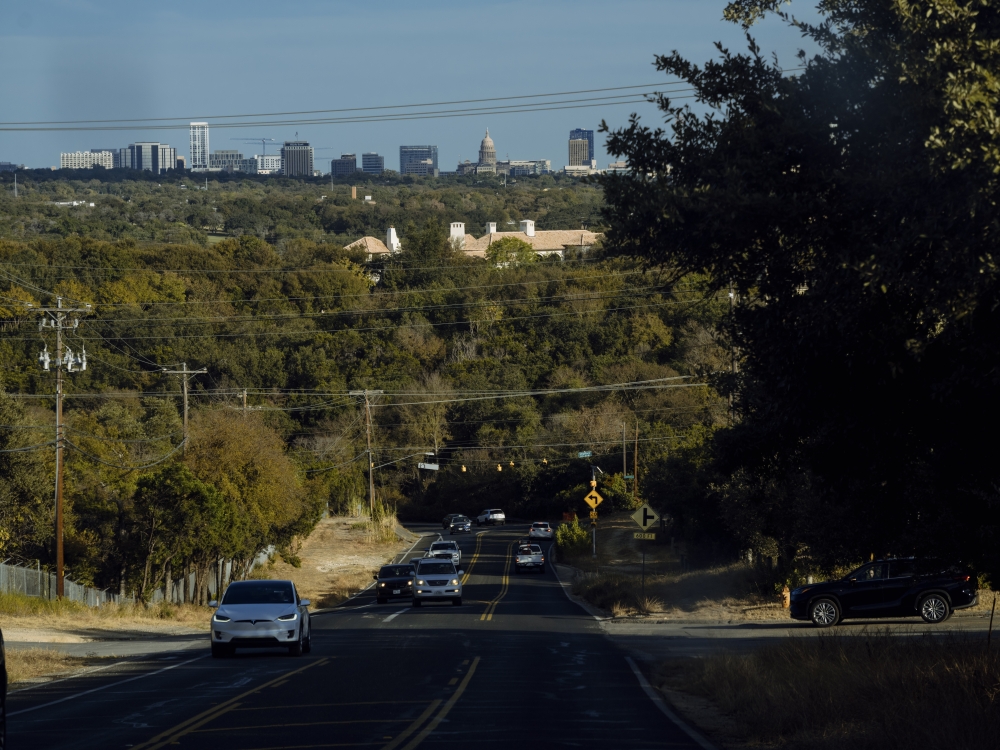 The skyline of Austin, seen from a road in the exclusive town of Westlake Hills, Texas, on Oct. 22, 2024. (Jordan Vonderhaar/The New York Times)