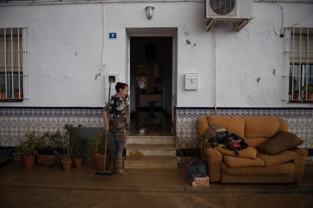 A woman cleans her home in Cartama, near Malaga, on October 30, 2024, after heavy rains hit southern Spain