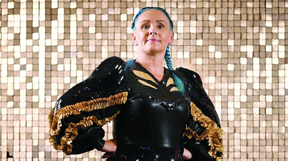 BRITAIN-TRADITION-SOCIETY-MORRIS DANCING
Emily Kenyon, 43, member of the Platt Bridge Carnival Morris dancing group, poses for portraits  on the sidelines of the REMIX End of Season Championships at the Blackpool Tower Ballroom, in Blackpool, north west of England, on September 15, 2024. Carnival Morris, also called “Fluffy” Morris, is a women and girls competitive team formation dance that is practised in the North-west of England and parts of North Wales. This traditional hobby is usually passed from mother to daughter. In fact, in the Platt Bridge group, we can find three generations of women grandmother, mother and daughter, performing for the same team in different categories.  (Photo by BEN STANSALL / AFP)
