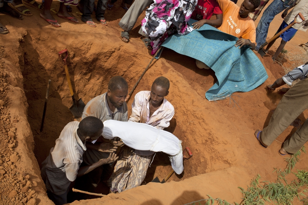 A four-year-old Somali girl who died in a refugee camp during the famine that struck Kenya and Somalia is buried at a makeshift cemetery in Dadaab, Kenya, July 14, 2011. (Tyler Hicks/The New York Times)