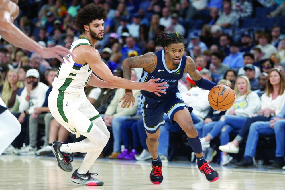 Memphis Grizzlies guard Ja Morant (12) drives to the basket as Milwaukee Bucks guard Andre Jackson Jr. (44) defends during the second half at FedExForum. Mandatory Credit: Petre Thomas-Imagn Images