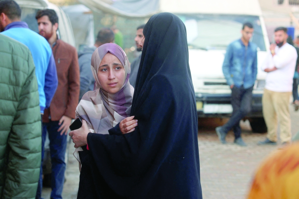 Women react after identifying a victim killed an Israeli strike on the Nuseirat refugee camp in the central Gaza Strip on Friday. — AFP
