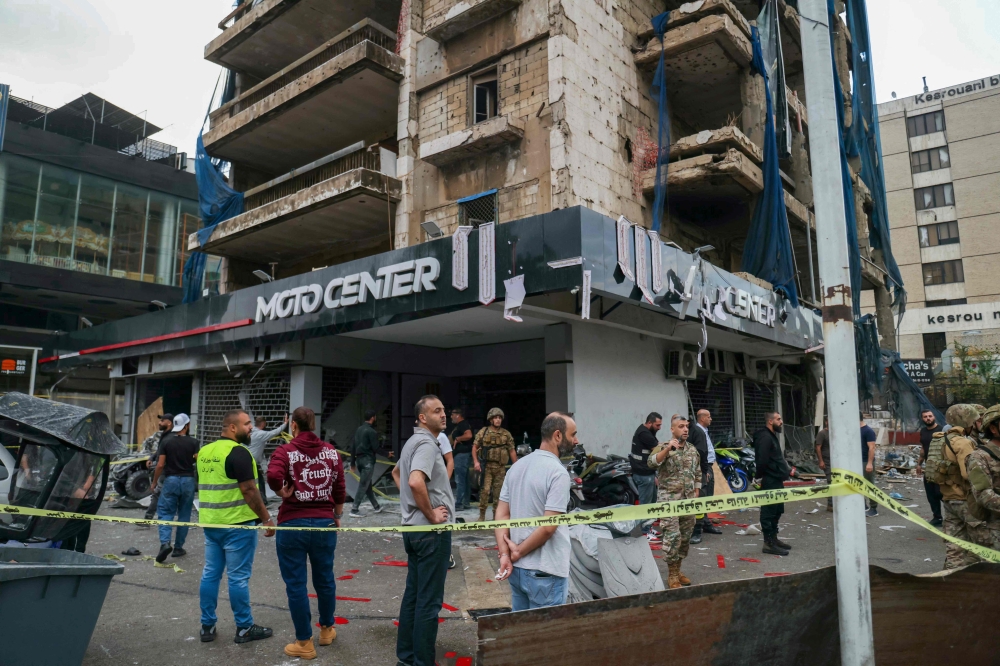 Lebanese army soldiers secure the area outside a building that was targeted in an Israeli airstrike in Beirut's southern suburbs. — AFP