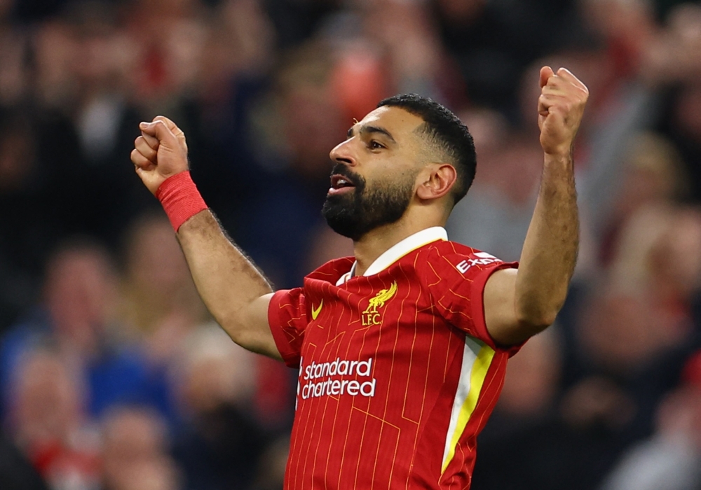Liverpool's Mohamed Salah celebrates scoring second goal. — Reuters
