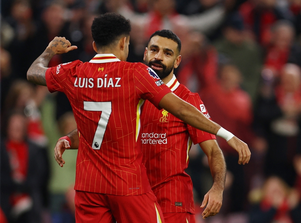 Liverpool's Mohamed Salah celebrates with Diaz. — Reuters