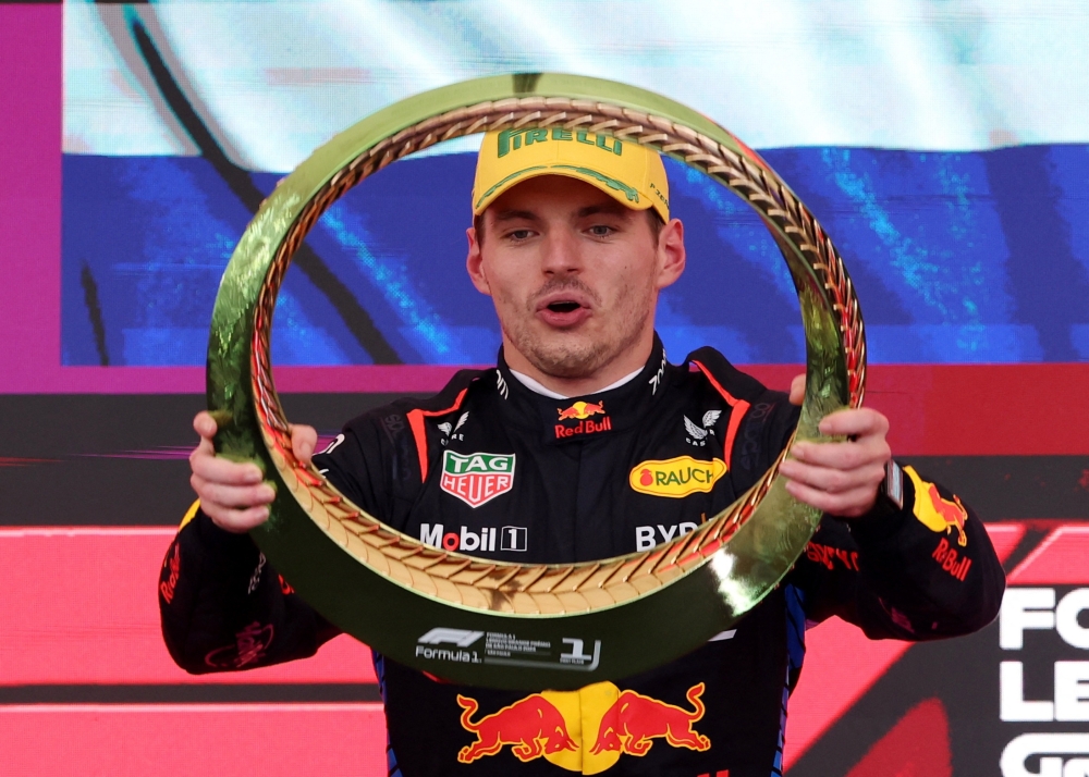 Formula One F1 - Sao Paulo Grand Prix - Autodromo Jose Carlos Pace, Sao Paulo, Brazil - November 3, 2024 Red Bull's Max Verstappen celebrates with a trophy on the podium after winning the Sao Paulo Grand Prix REUTERS/Amanda Perobelli
