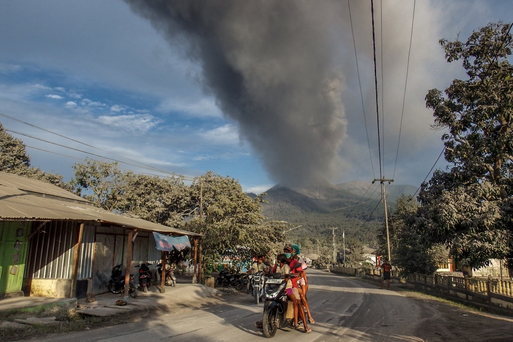 Villagers flee during an eruption of Mount Lewotobi Laki-Laki, in East Flores, Indonesia. — AFP 