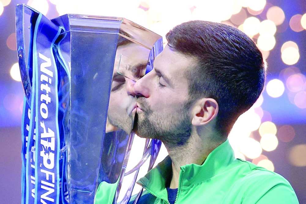 FILE PHOTO: Pala Alpitour, Turin, Italy - November 19, 2023  Serbia's Novak Djokovic celebrates with the trophy after winning the final against Italy's Jannik Sinner. — REUTERS