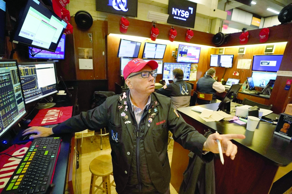 Trader Jonathan Mueller wears a Trump hat as he works on the floor of the New York Stock Exchange (NYSE) at the opening bell in New York City. — AFP 