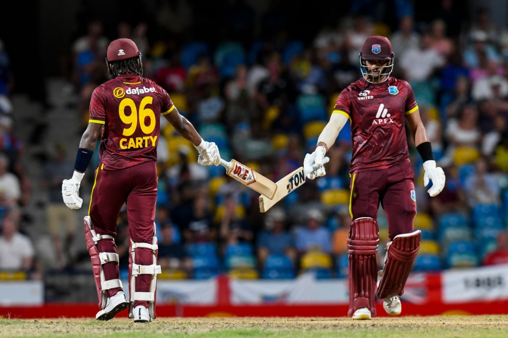 Brandon King (R) and Keacy Carty (L) of West Indies 100 runs partnership during the 3rd and final ODI match between West Indies and England at Kensington Oval, Bridgetown, Barbados, on November 6, 2024. (Photo by Randy Brooks / AFP)

