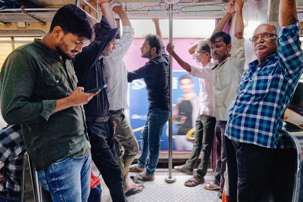 Commuters on a train in Mumbai, India, in October 2024. (Poras Chaudhary/The New York Times)