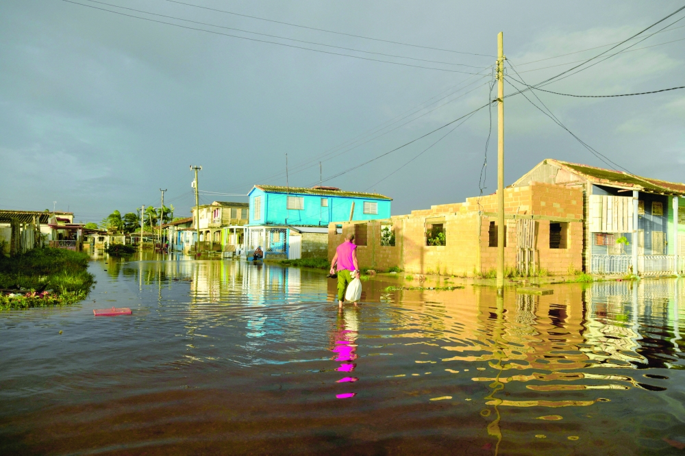 A man walks in a flooded street
