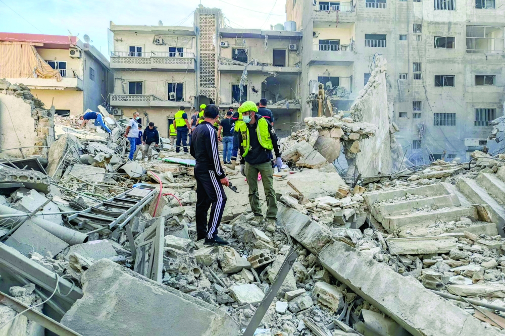 Rescuers gather at the site of overnight Israeli air strikes that targeted the city of Tyre. — AFP