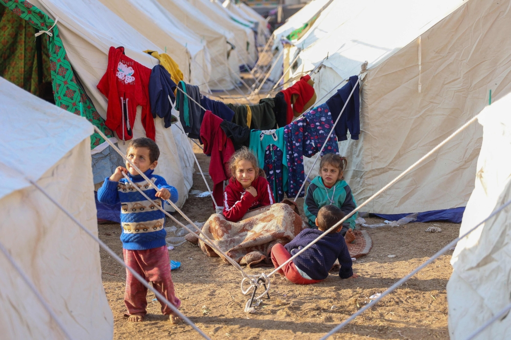 Children play at a camp for displaced Palestinians set up at Palestine Stadium in Gaza City,