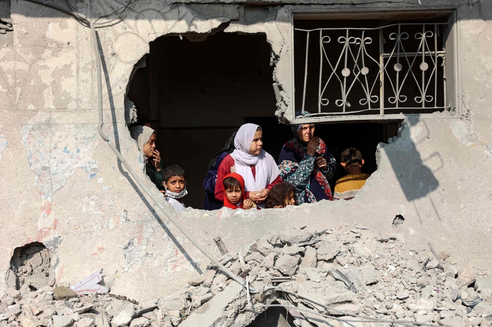 Palestinians stare at the destruction following an Israeli strike in Jabalia in the northern Gaza Strip. — AFP 