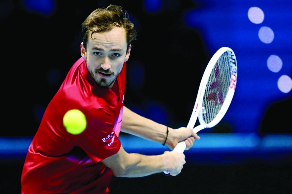Russia's Daniil Medvedev hits a return to Australia's Alex De Minaur during their match at the ATP Finals tennis tournament in Turin on November 12, 2024. 