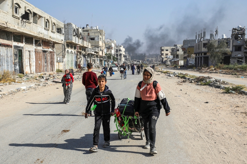 Displaced Palestinians make their way after fleeing the northern part of Gaza. — Reuters 