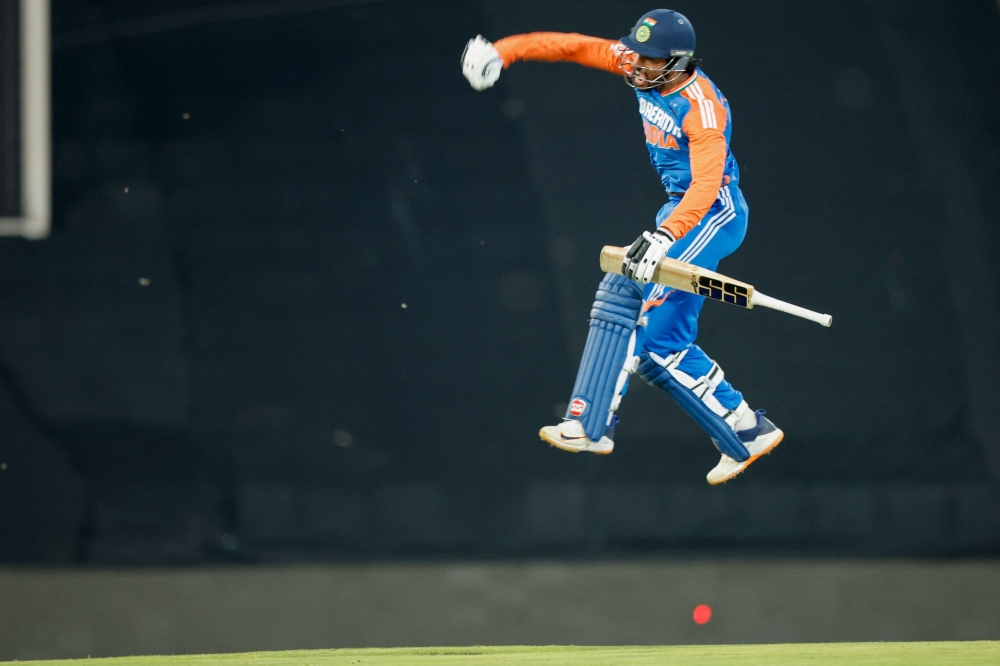 TOPSHOT - India's Tilak Varma celebrates after scoring a century (100 runs) during the third T20 international cricket match between South Africa and India at SuperSport Park in Centurion on November 13, 2024. (Photo by PHILL MAGAKOE / AFP)

