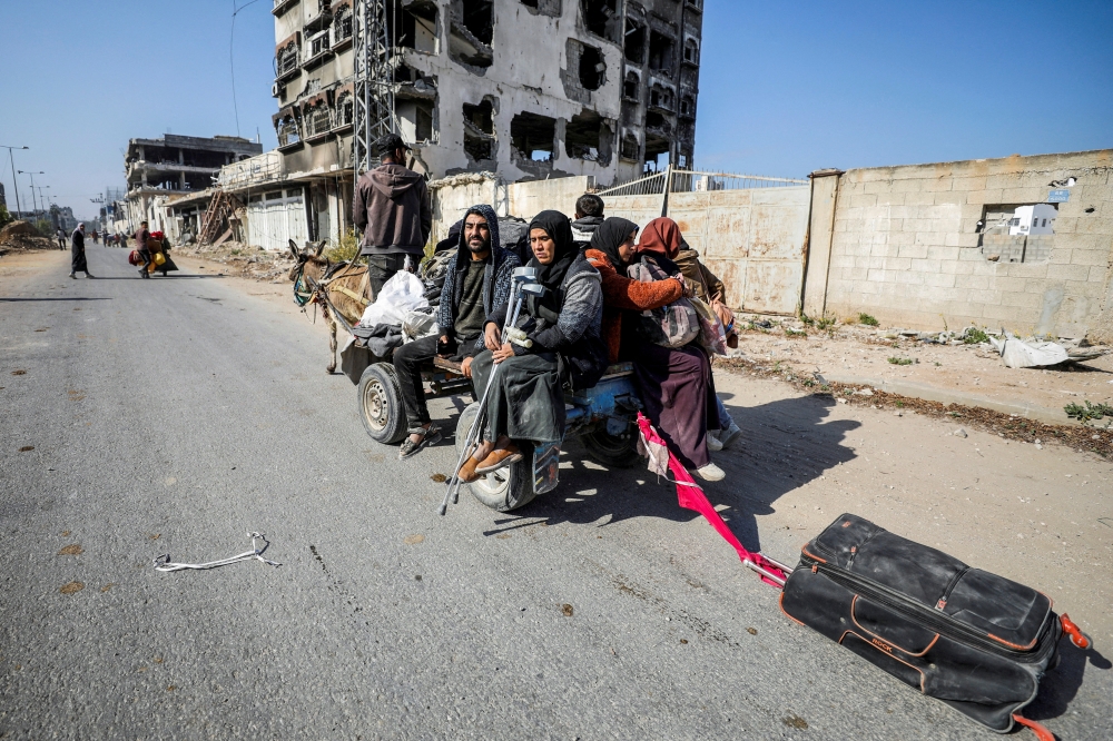 Displaced Palestinians make their way after fleeing the northern part of Gaza amid an Israeli military operation. — Reuters 
