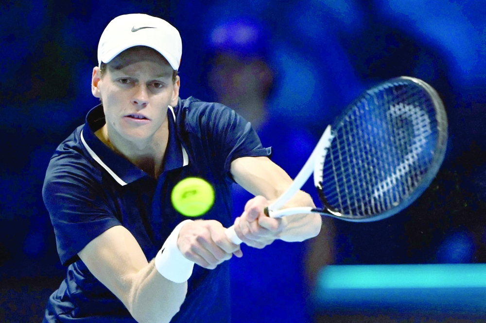 Italy's Jannik Sinner hits a return to Russia's Daniil Medvedev during their match at the ATP Finals tennis tournament in Turin on November 14, 2024. 