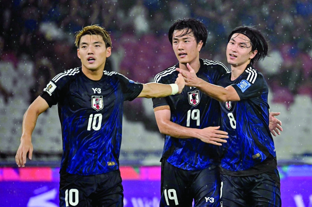 Koki Ogawa (C) celebrates with his team-mates after scoring his team's first goal during the 2026 World Cup Asian Group C qualification football match between Indonesia and Japan.
