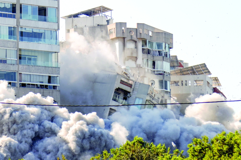 A building collapses after an Israeli air strike on Beirut's southern Ghobeiri neighbourhood. — AFP