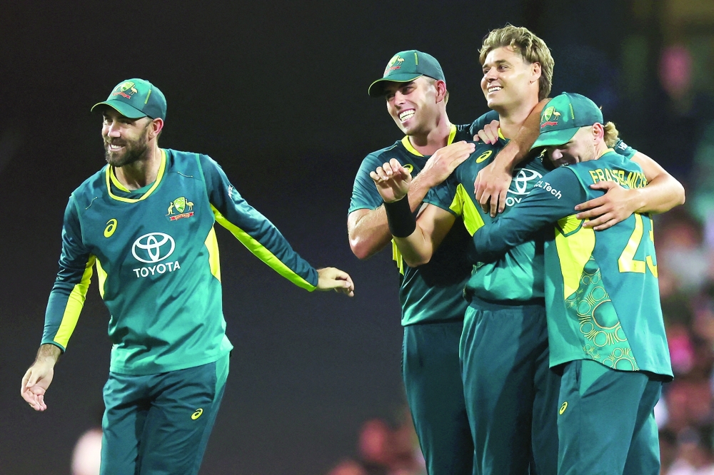 Australia's Spencer Johnson celebrates with teammates. — AFP
