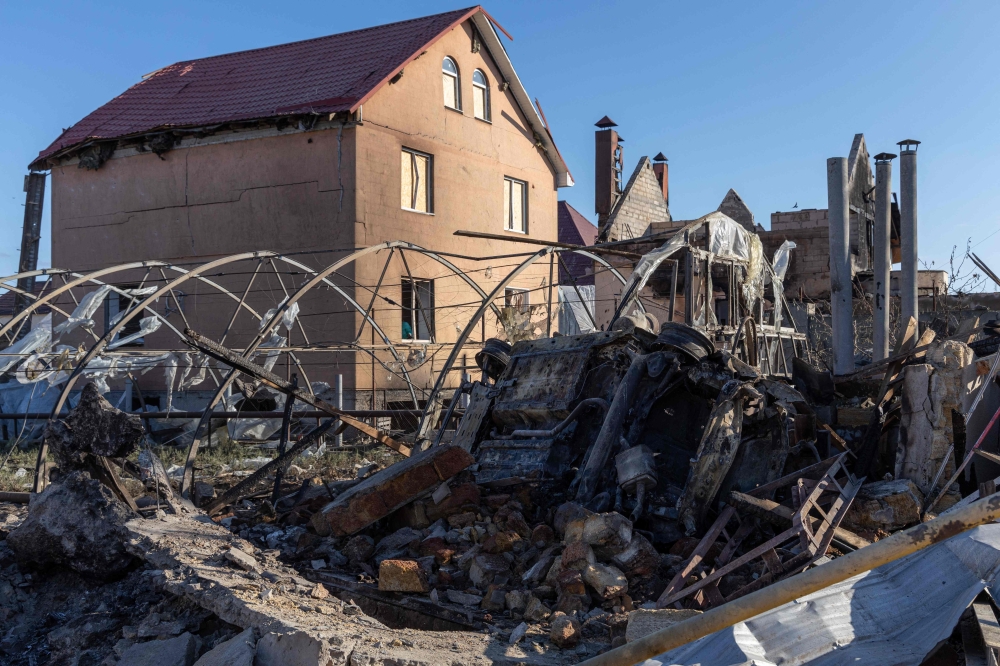 A destroyed car among debris in the courtyard of a damaged house following a missile attack in Odesa region, Ukraine. — AFP 