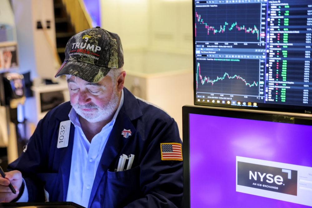 A trader wears a hat in support of Republican Donald Trump, after he won the US presidential election, at the New York Stock Exchange (NYSE) in New York City. — Reuters