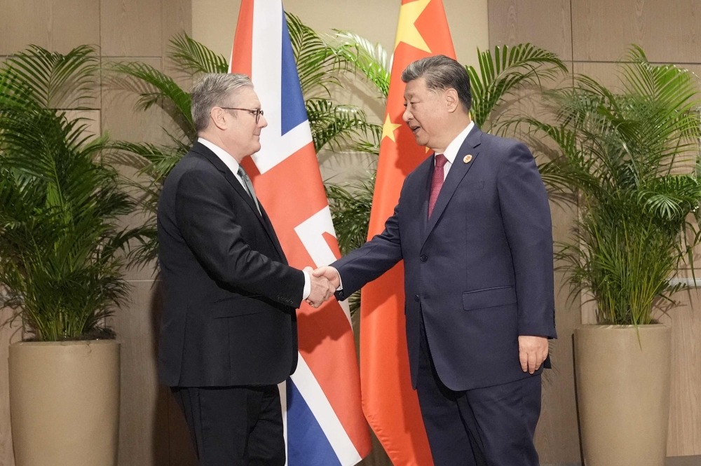 Britain's Prime Minister Keir Starmer (L) shakes hands with China's President Xi Jinping, on the sidelines of G20 summit in Rio de Janeiro, Brazil. — AFP 