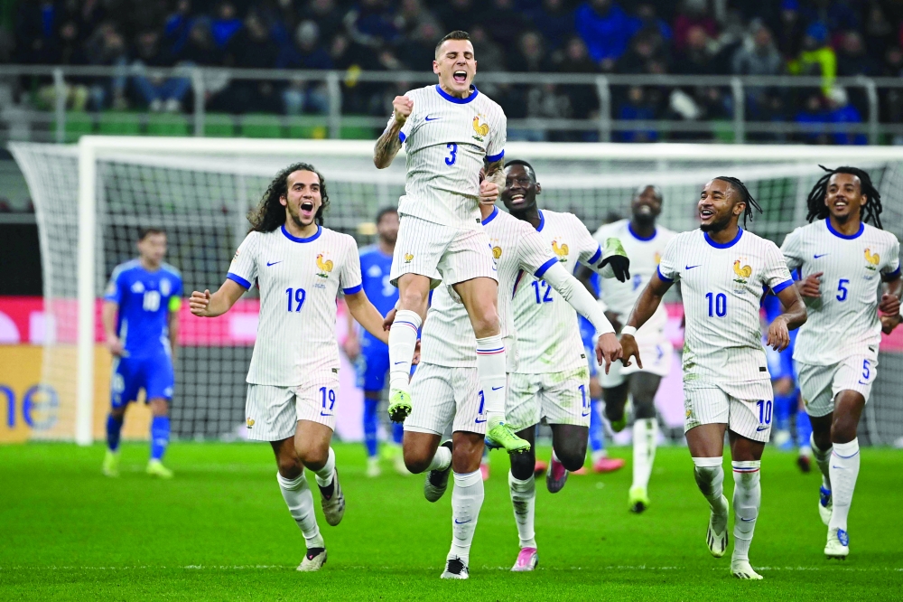 France's defender #03 Lucas Digne (C) celebrates scoring a goal. — AFP