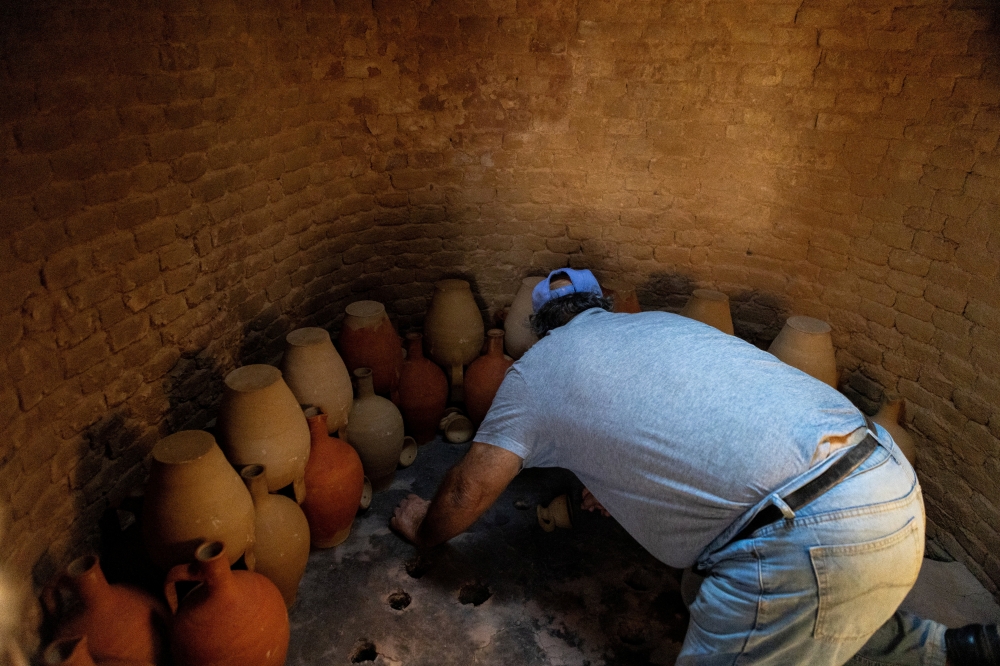 Nikos Kouvdis, 70, works in his pottery workshop using traditional methods in Agios Stefanos village, near Mandamados on the Greek island of Lesbos, Greece, September 23, 2024. His family’s dedication to preserving the craft was recently honored with inclusion in UNESCO’s National Inventory of Intangible Cultural Heritage. REUTERS/Elias Marcou
