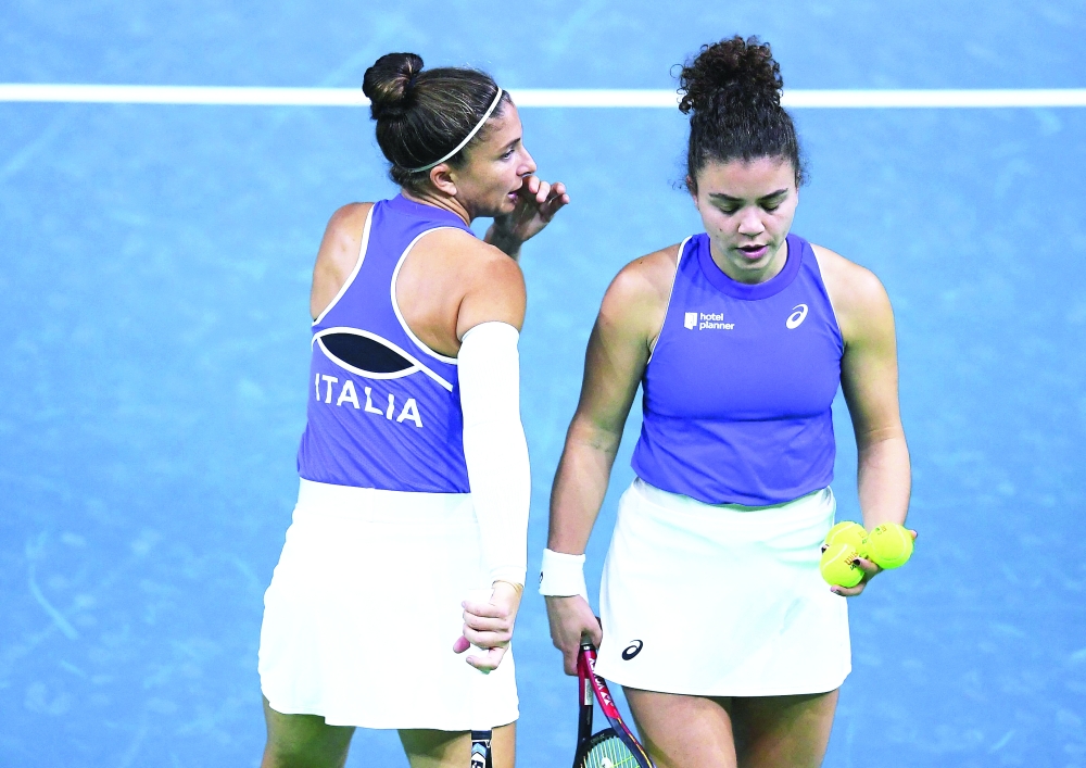 Italy's Jasmine Paolini and Sara Errani (L) talk during their semifinals doubles match against Poland at the Billie Jean King Cup Finals in Malaga, southern Spain. — AFP